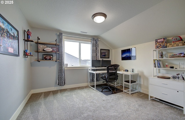 home office featuring carpet, baseboards, visible vents, vaulted ceiling, and a textured ceiling