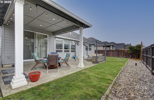 view of yard with a patio, a fenced backyard, and an outdoor hangout area