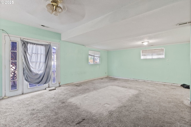 carpeted empty room with a textured ceiling