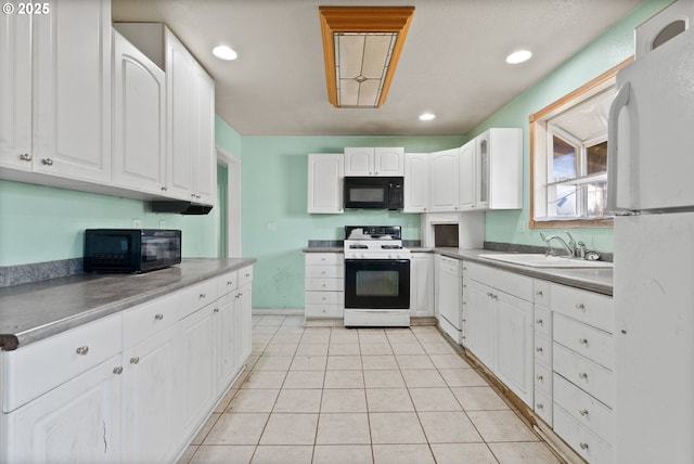 kitchen with sink, white appliances, light tile patterned floors, and white cabinets