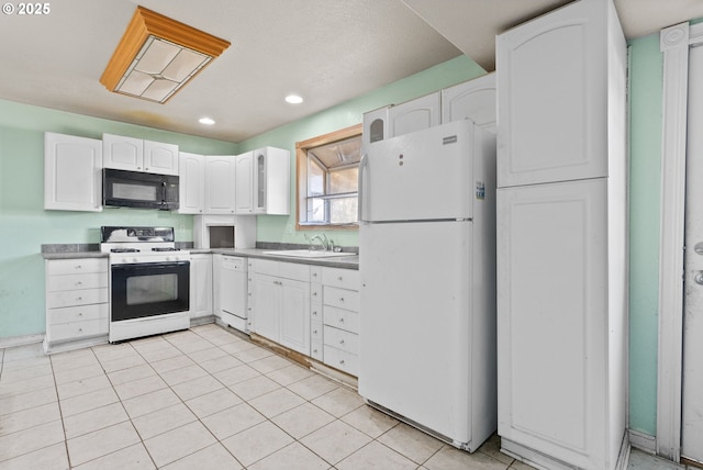 kitchen with white cabinetry, sink, light tile patterned floors, and white appliances