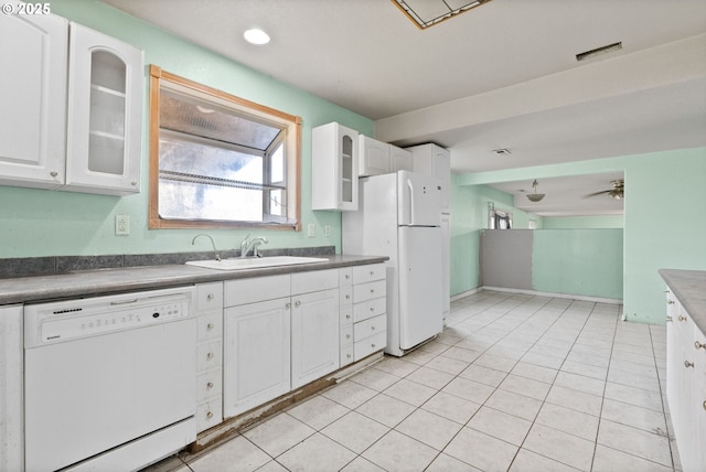 kitchen featuring sink, white appliances, white cabinets, and light tile patterned flooring