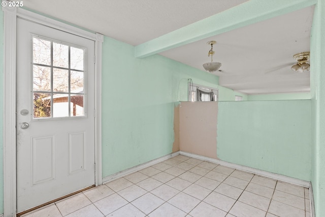 doorway to outside with beamed ceiling