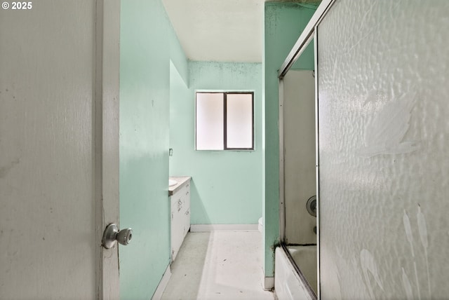 bathroom with vanity and shower / bath combination with glass door