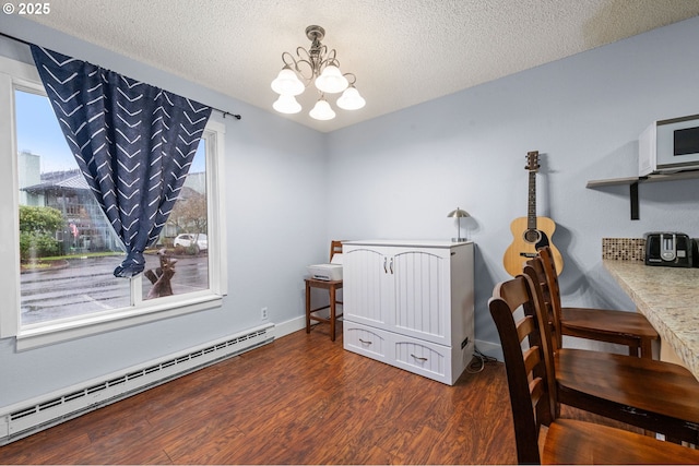 interior space featuring a baseboard radiator, a notable chandelier, a textured ceiling, and wood finished floors