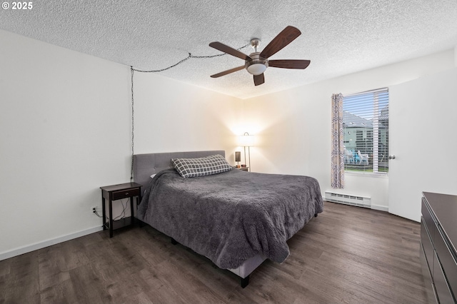 bedroom featuring a textured ceiling, baseboard heating, wood finished floors, and a ceiling fan