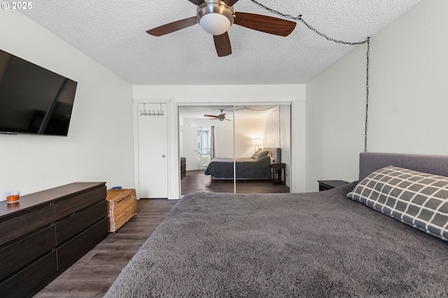 bedroom with a textured ceiling, ceiling fan, and wood finished floors