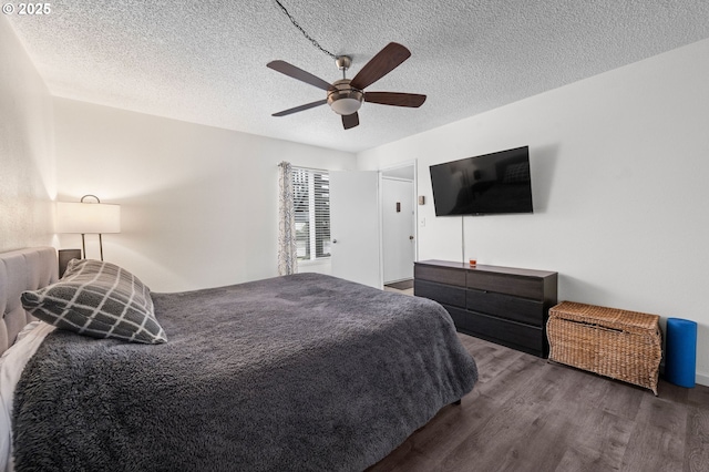 bedroom with ceiling fan, a textured ceiling, and wood finished floors