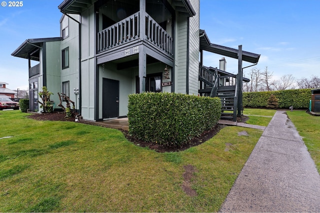 exterior space with stairway and a yard