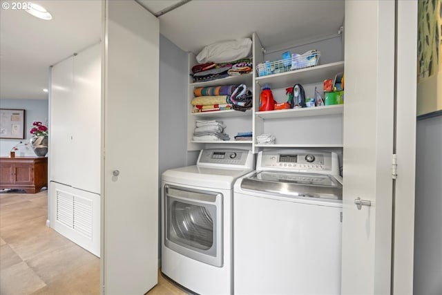 laundry room with laundry area, visible vents, and washer and dryer