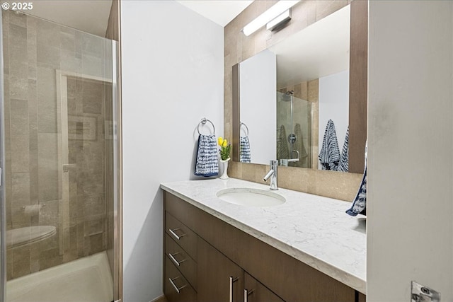 full bathroom with a stall shower and vanity