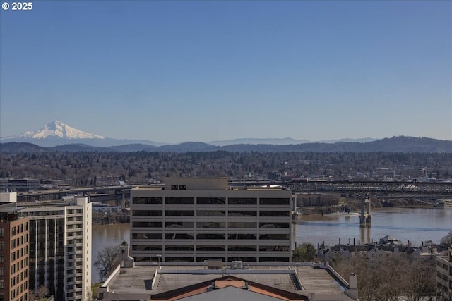 exterior space with a water and mountain view