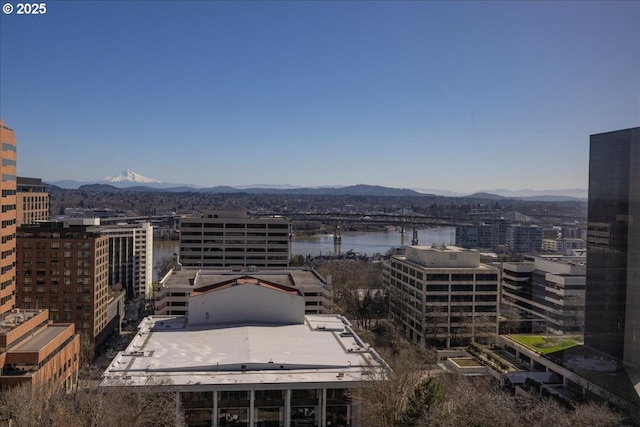 property's view of city with a water and mountain view