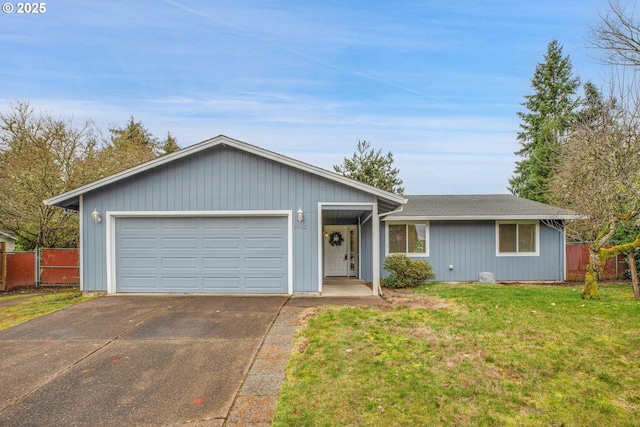 ranch-style home featuring a front lawn, fence, a garage, and driveway