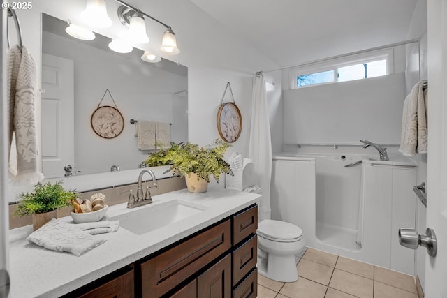 bathroom with tile patterned flooring, a shower with shower curtain, toilet, and vanity