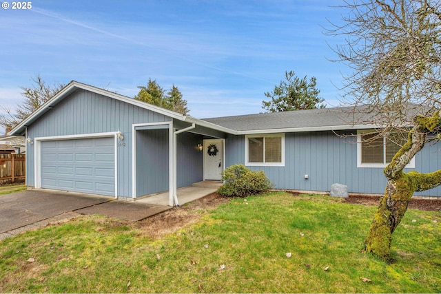 single story home featuring an attached garage, driveway, a front lawn, and fence