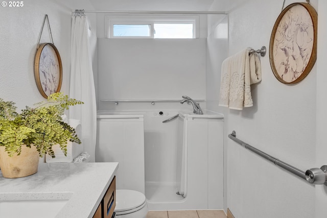 bathroom with tile patterned floors, a shower with curtain, vanity, and toilet