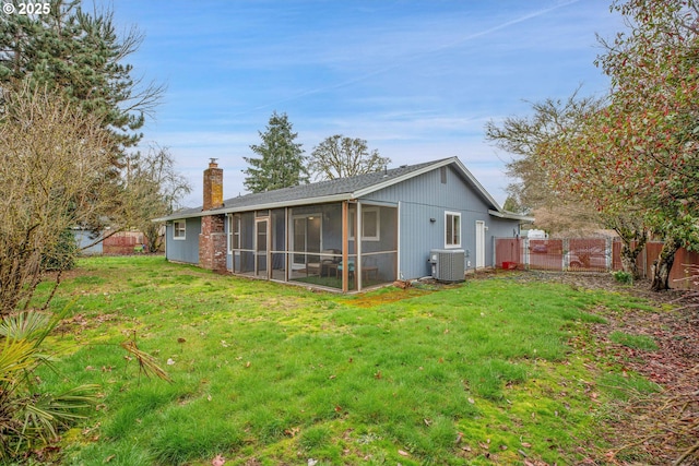 back of property featuring a lawn, cooling unit, a chimney, and fence