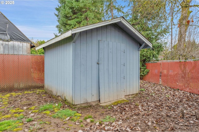 view of shed featuring fence