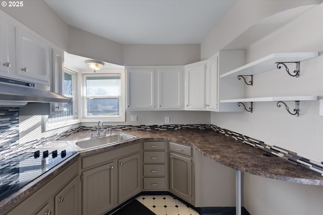 kitchen with white cabinetry, black cooktop, sink, and gray cabinetry