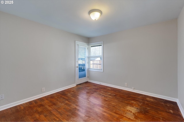 empty room with dark hardwood / wood-style flooring