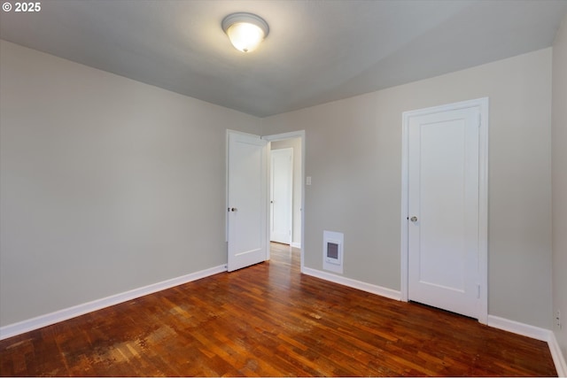 spare room with dark hardwood / wood-style flooring