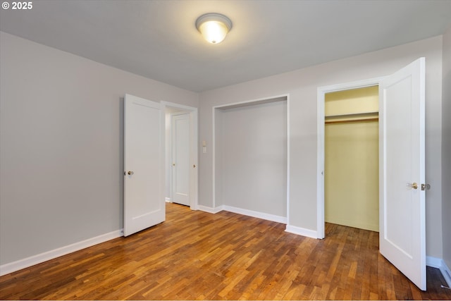 unfurnished bedroom with dark hardwood / wood-style floors