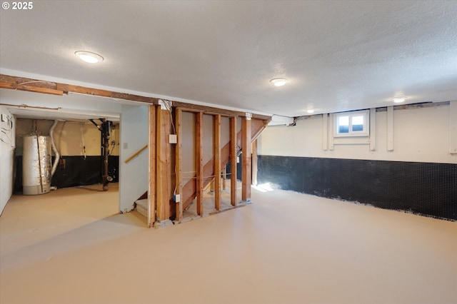 basement with gas water heater and a textured ceiling