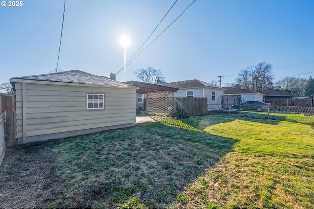 back of property featuring a carport and a lawn