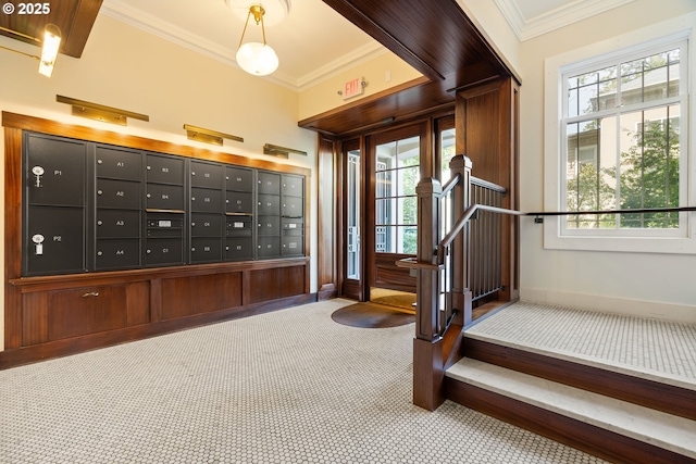 stairway with crown molding, mail area, baseboards, carpet flooring, and healthy amount of natural light