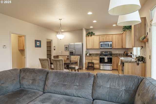 living room featuring sink and light hardwood / wood-style flooring