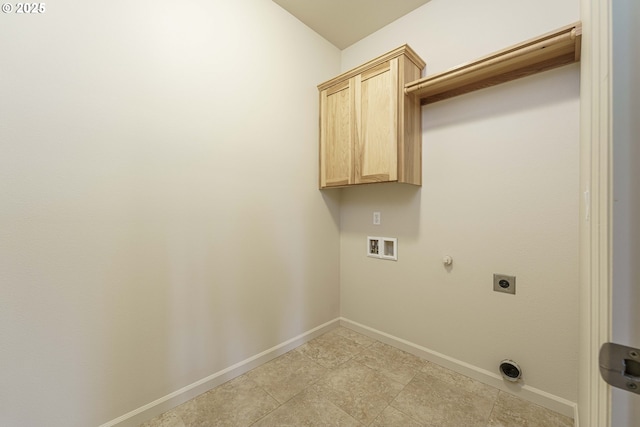 clothes washing area featuring washer hookup, electric dryer hookup, hookup for a gas dryer, and cabinets