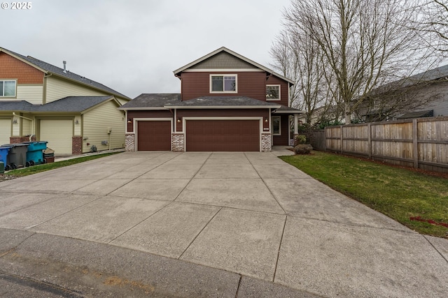 craftsman inspired home featuring a garage and a front yard