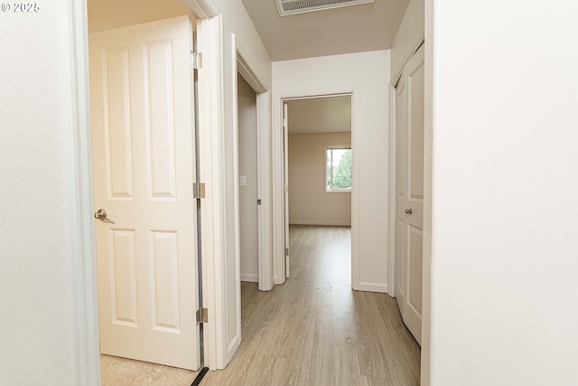 hallway with light wood-type flooring