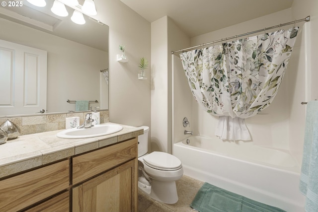 full bathroom featuring toilet, tile patterned floors, vanity, and shower / bathtub combination with curtain