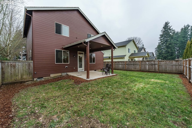 rear view of property with a yard and a patio area