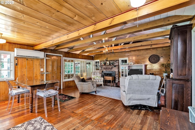 63645 E Barlow Trail Rd, Brightwood, OR 97011 - living room featuring a wall mounted air conditioner, wood walls, hardwood / wood-style floors, a wooden ceiling with exposed beams, and a brick fireplace