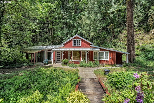 63645 E Barlow Trail Rd, Brightwood, OR 97011 - view of front of home with a porch, a metal roof, a forest view, and a standing seam roof