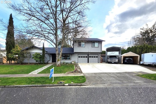 view of front of property featuring a garage, concrete driveway, and a front yard