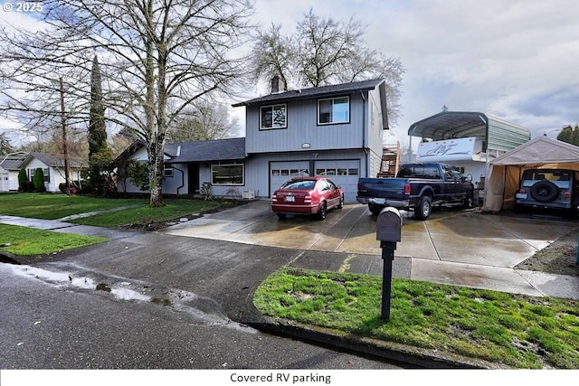 view of front of house with a chimney, a detached carport, an attached garage, driveway, and a front lawn