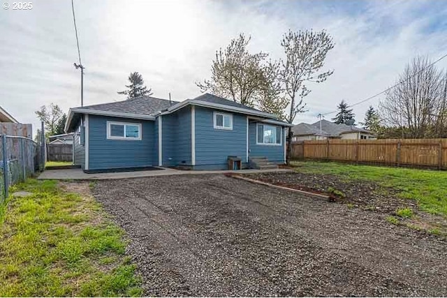 back of house with a fenced backyard