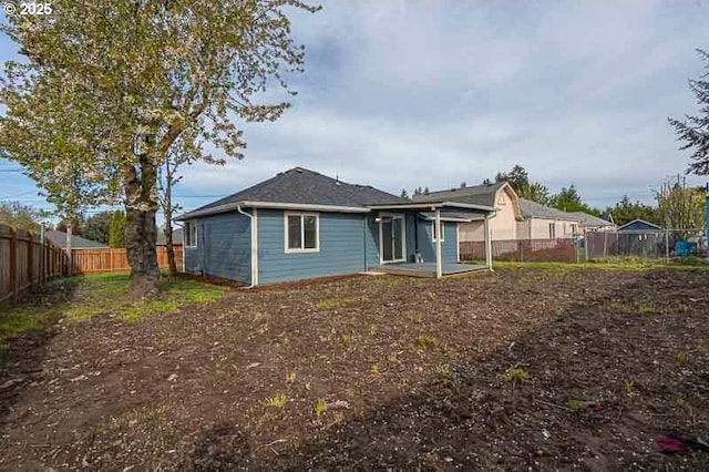 back of house featuring a fenced backyard