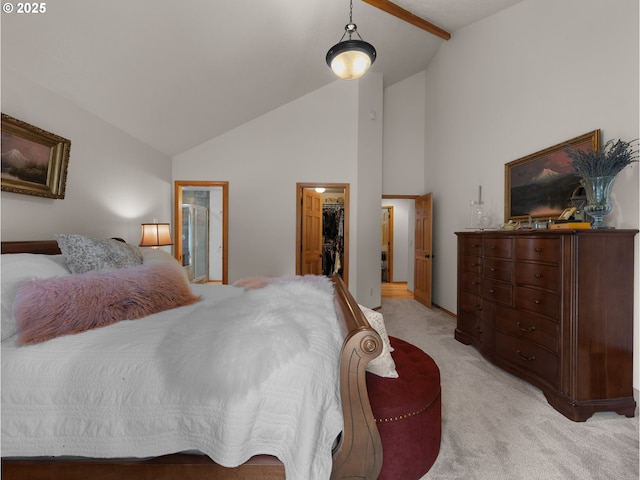 bedroom with a closet, baseboards, a walk in closet, high vaulted ceiling, and light colored carpet