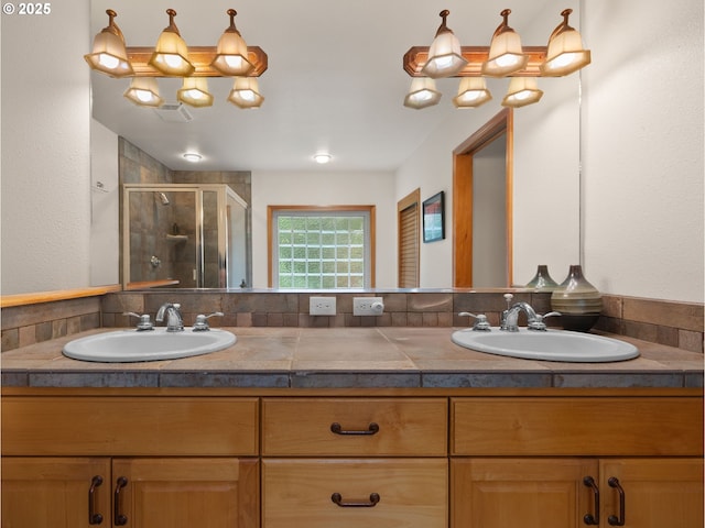 full bath featuring double vanity, visible vents, a sink, and a stall shower