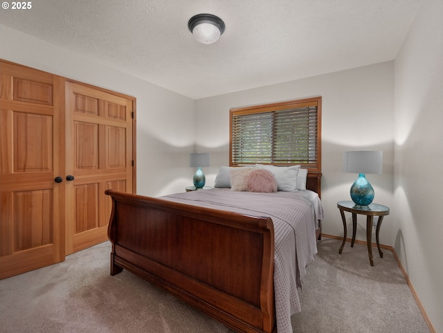 bedroom featuring baseboards and light colored carpet