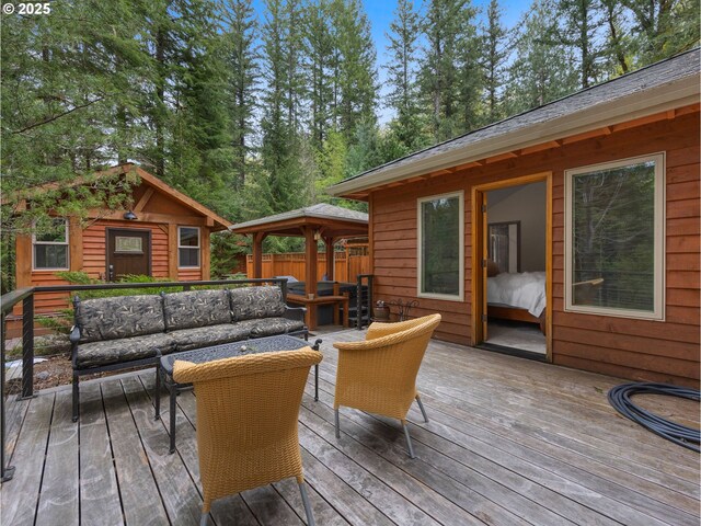deck featuring a gazebo and outdoor lounge area