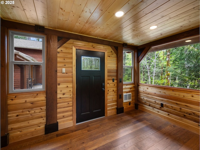 foyer entrance featuring wood ceiling, visible vents, dark wood finished floors, wood walls, and recessed lighting