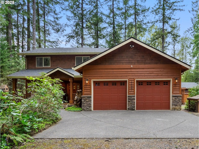 view of front of house with concrete driveway, an attached garage, covered porch, and stone siding