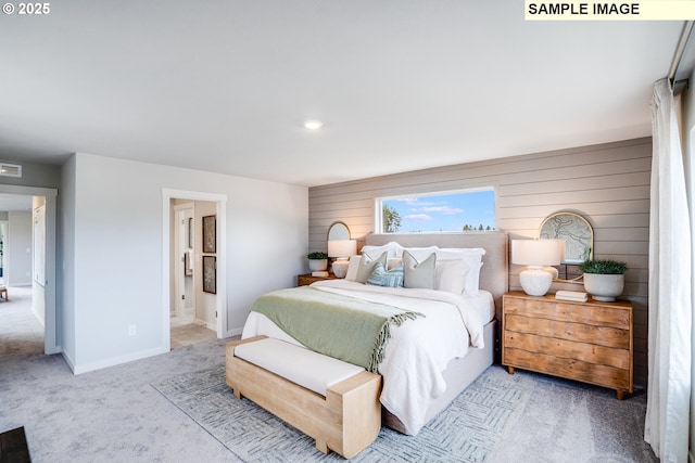 carpeted bedroom with baseboards and ensuite bathroom
