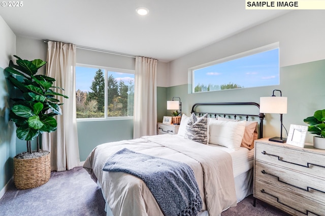 carpeted bedroom featuring multiple windows and recessed lighting